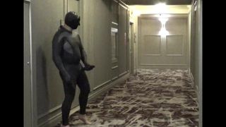 barefoot masked wetsuited guy in hotel hall with cock extension